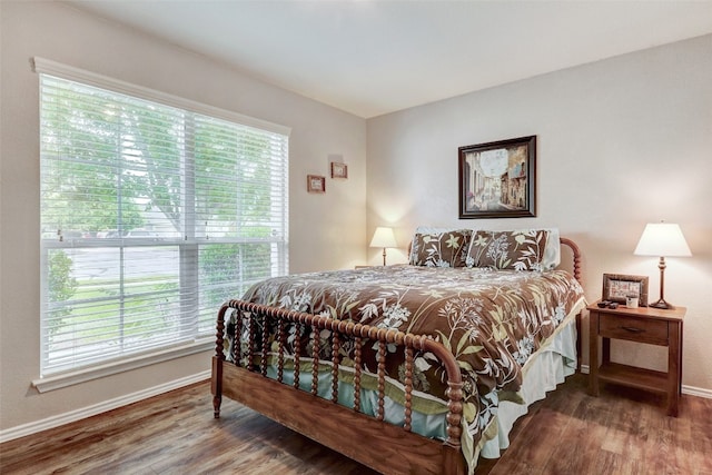 bedroom with multiple windows and hardwood / wood-style floors