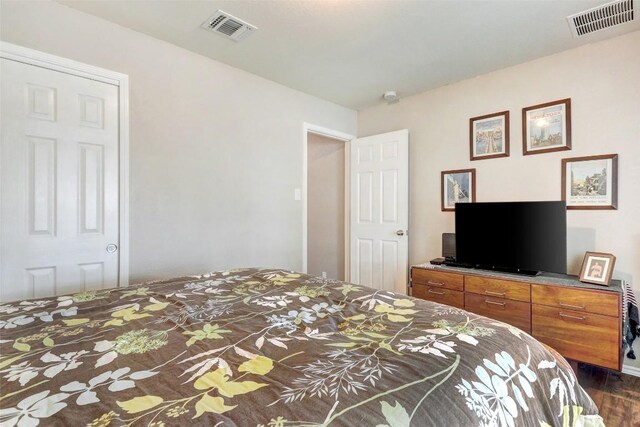 bedroom with dark hardwood / wood-style floors