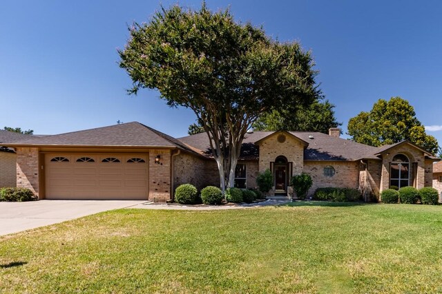 single story home with a garage and a front yard