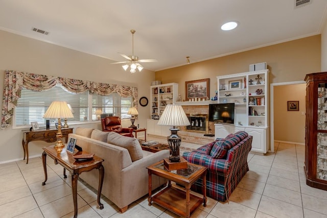 living room with a fireplace, ornamental molding, ceiling fan, and light tile patterned flooring