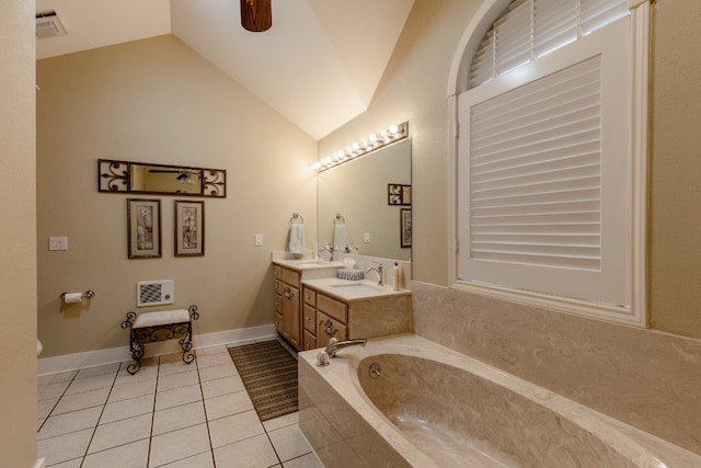 bathroom with tiled tub, tile patterned flooring, lofted ceiling, and double sink vanity