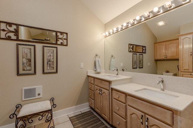 bathroom with vanity, tile patterned flooring, toilet, and vaulted ceiling