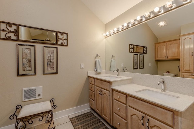 bathroom featuring tile patterned flooring, vanity, heating unit, vaulted ceiling, and toilet