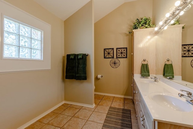 bathroom featuring vanity, tile patterned floors, and lofted ceiling