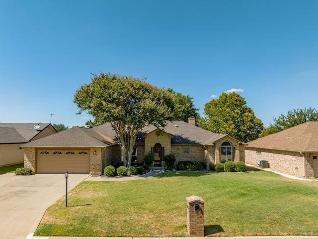 single story home with a garage and a front lawn