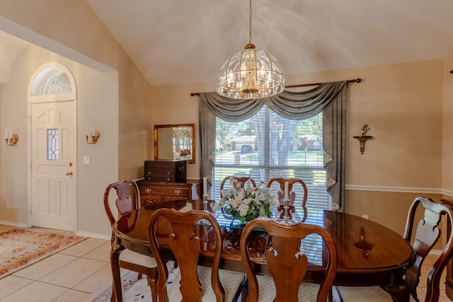 dining room with a chandelier, lofted ceiling, and light tile patterned floors