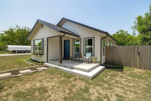 rear view of house featuring a lawn