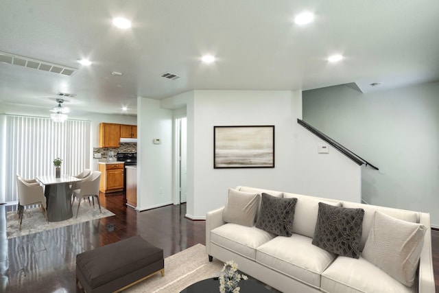 living room featuring dark wood-type flooring