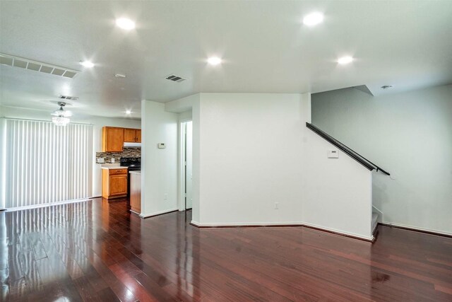 unfurnished living room featuring dark wood-type flooring