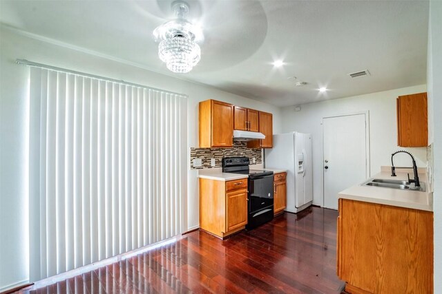 kitchen with sink, black range with electric stovetop, decorative backsplash, dark wood-type flooring, and white fridge with ice dispenser