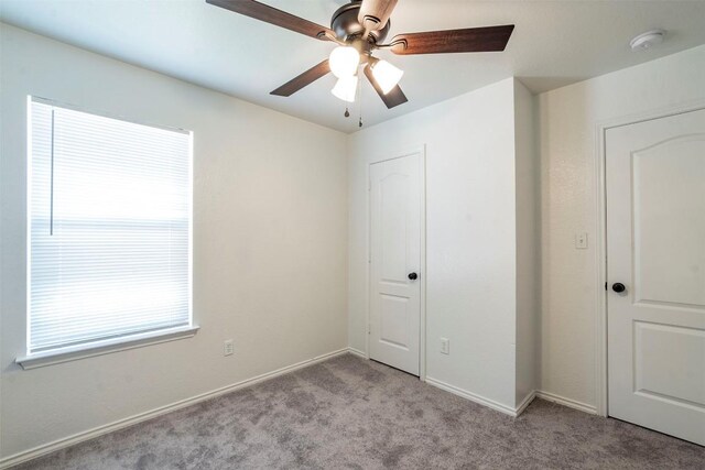 unfurnished bedroom with ceiling fan and carpet flooring