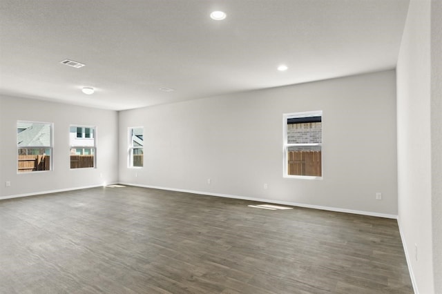 unfurnished room with dark hardwood / wood-style flooring