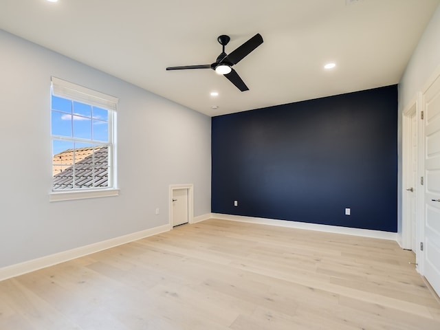 unfurnished room featuring ceiling fan and light wood-type flooring