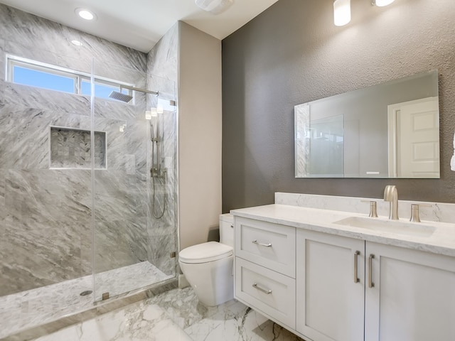 bathroom with walk in shower, vanity, and toilet