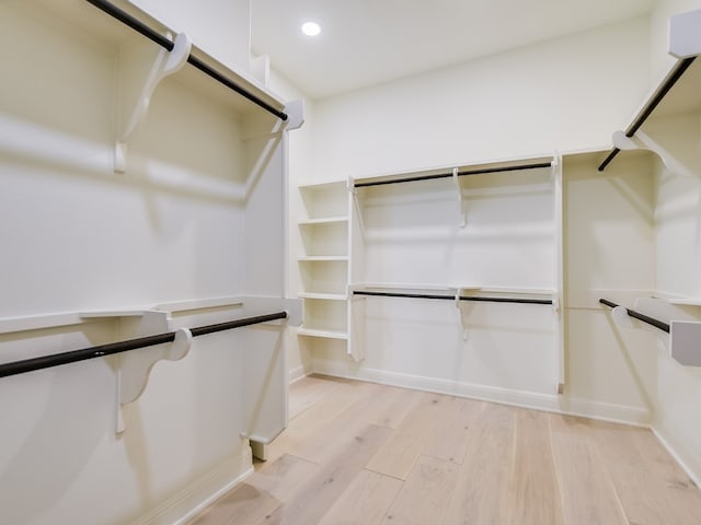 spacious closet with light hardwood / wood-style flooring