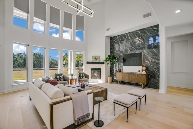 living room featuring hardwood / wood-style flooring and a towering ceiling