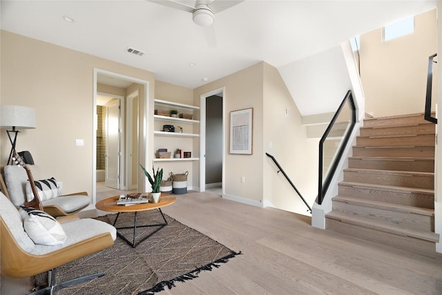 living room with hardwood / wood-style flooring and ceiling fan