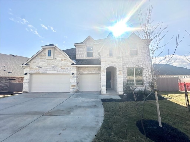 view of front of house with a garage, stone siding, concrete driveway, and fence