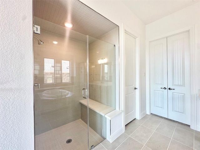 full bathroom featuring tile patterned flooring and a stall shower