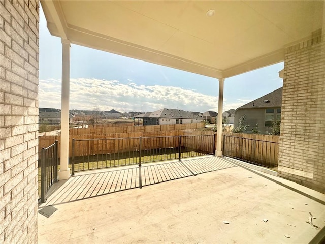 view of patio / terrace featuring a residential view and fence