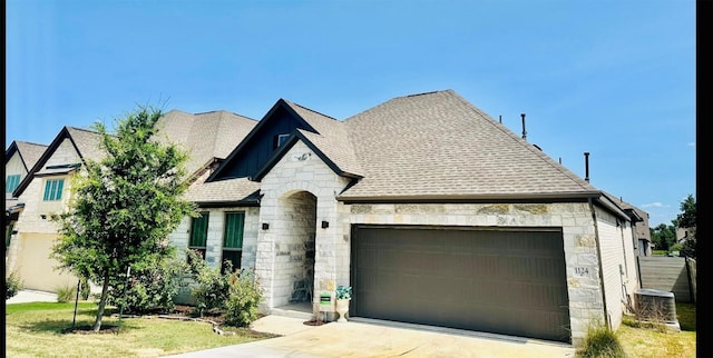 french country inspired facade with a garage and central AC