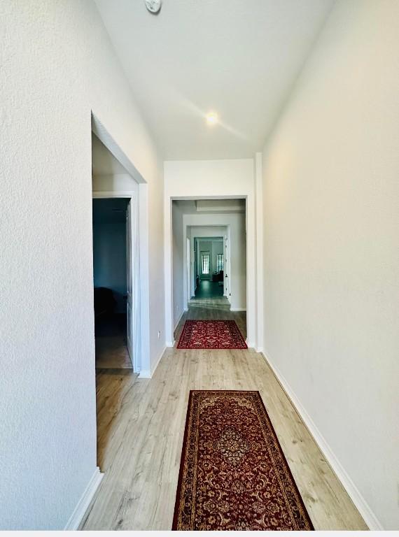 corridor featuring light hardwood / wood-style floors