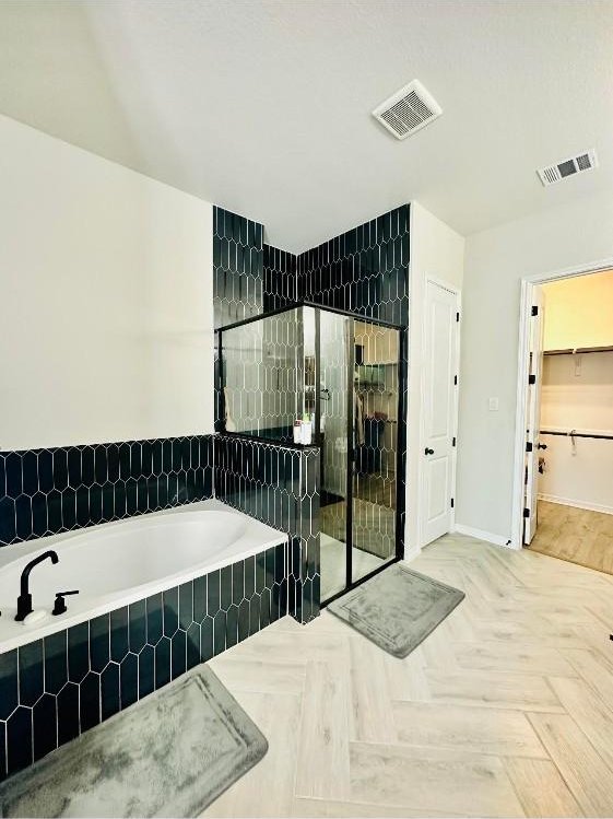 bathroom with parquet floors and plus walk in shower