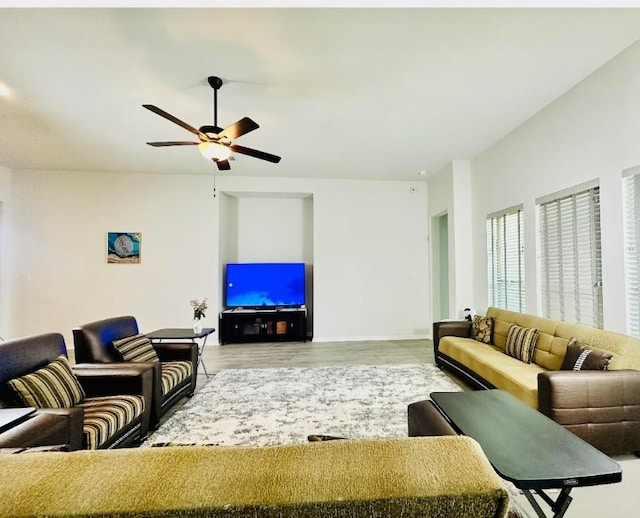 living room featuring hardwood / wood-style floors and ceiling fan