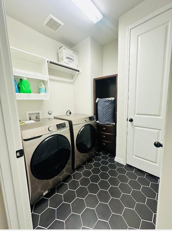 clothes washing area with washing machine and clothes dryer