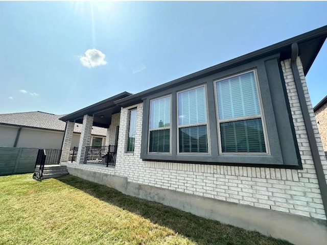 view of home's exterior with a yard