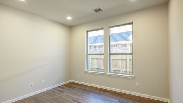 unfurnished room with wood-type flooring