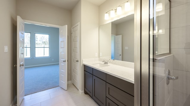 bathroom featuring vanity, tile patterned flooring, and tiled shower