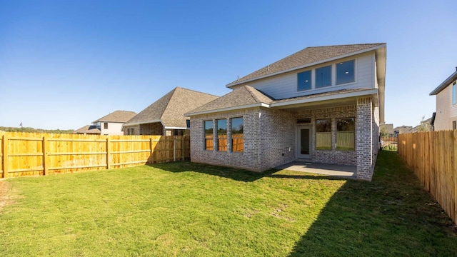 rear view of house with a patio area and a yard