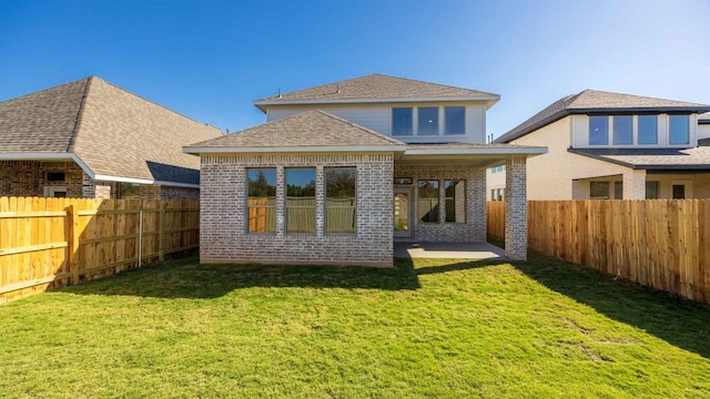 rear view of property featuring a yard and a patio area