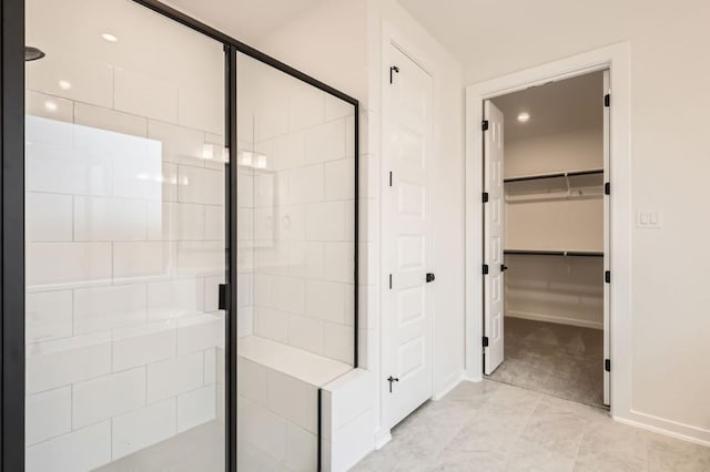 bathroom with a shower with door