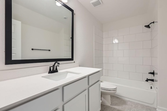 full bathroom featuring toilet, vanity, and tiled shower / bath combo