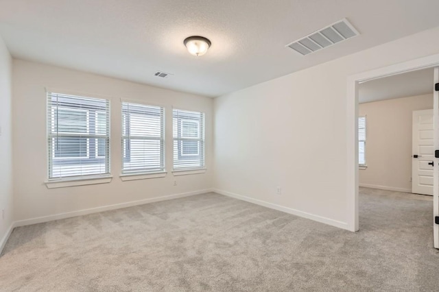 unfurnished room with light carpet