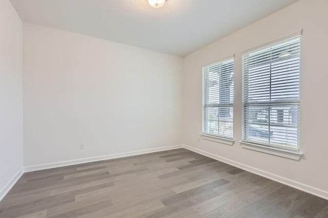 spare room with hardwood / wood-style floors