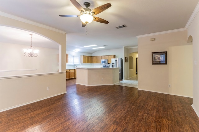 unfurnished living room with ceiling fan with notable chandelier, light hardwood / wood-style floors, and ornamental molding