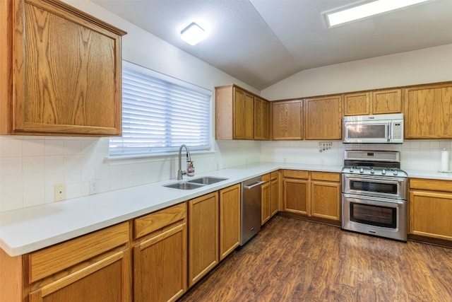 kitchen featuring appliances with stainless steel finishes, tasteful backsplash, sink, lofted ceiling, and dark hardwood / wood-style flooring