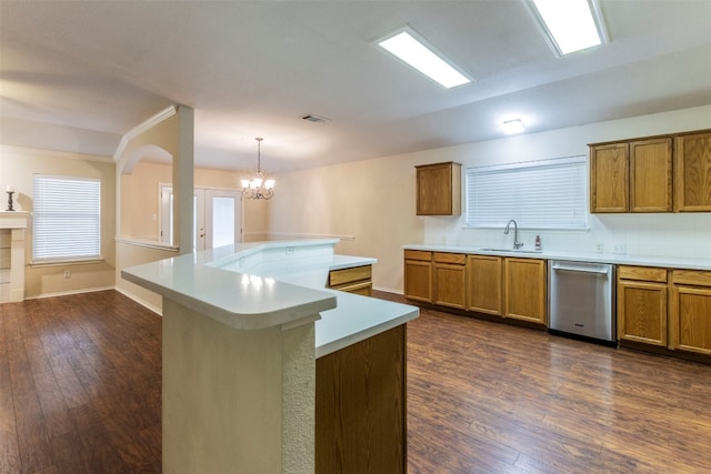 kitchen featuring dishwasher, sink, hanging light fixtures, dark wood-type flooring, and a notable chandelier