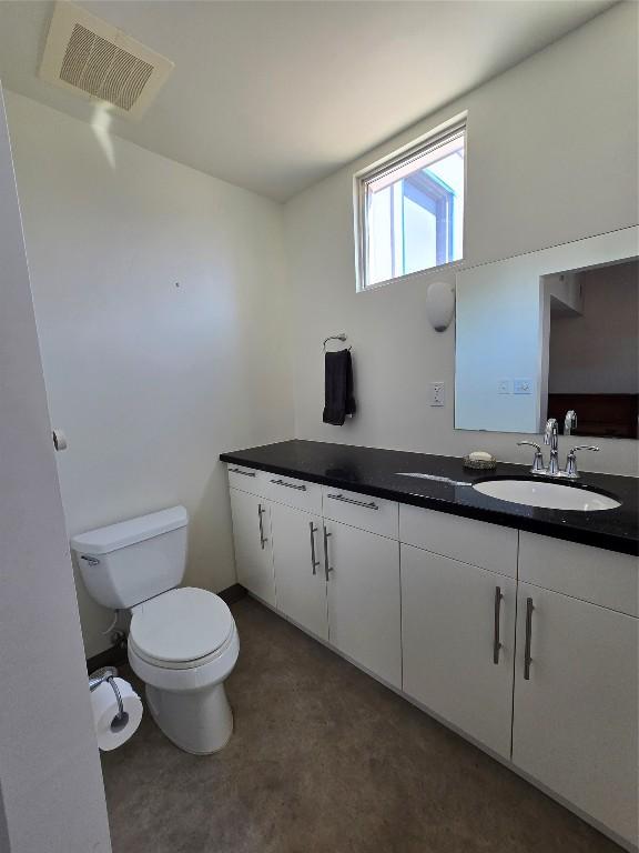 bathroom featuring vanity and toilet