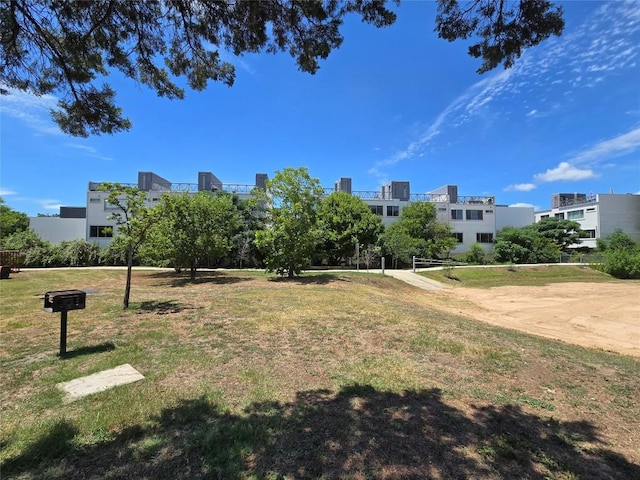 view of home's community featuring a lawn