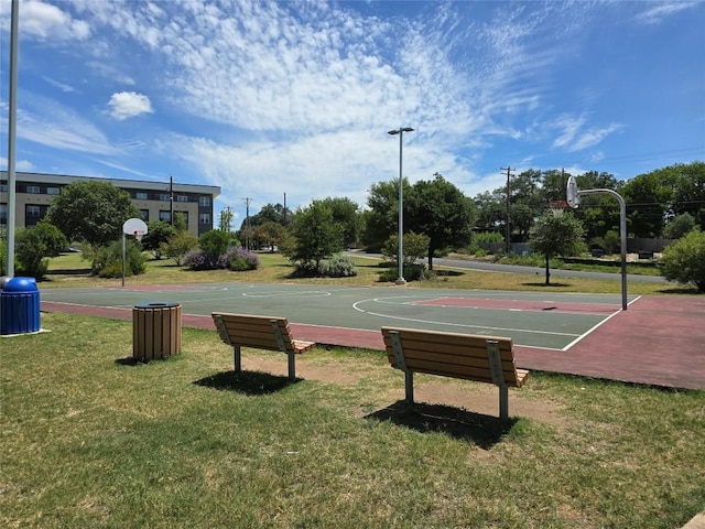 view of sport court featuring a lawn