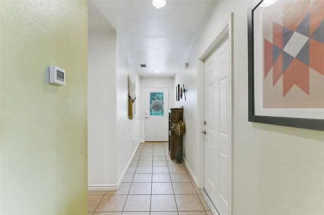 hallway with light tile patterned floors