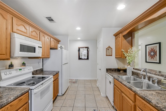 kitchen featuring sink, white appliances, and light tile patterned floors