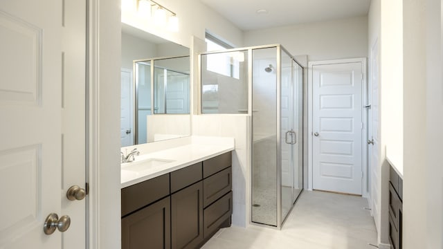 bathroom with vanity and a shower with shower door