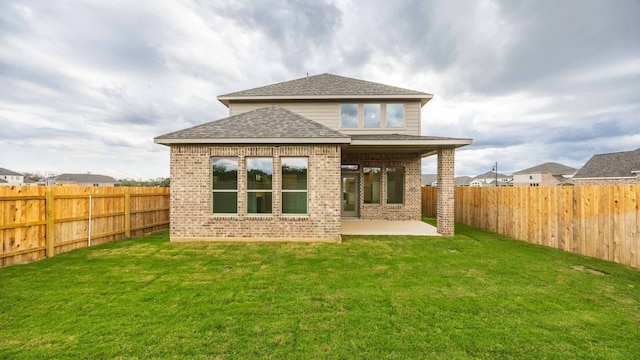 back of property featuring a yard and a patio