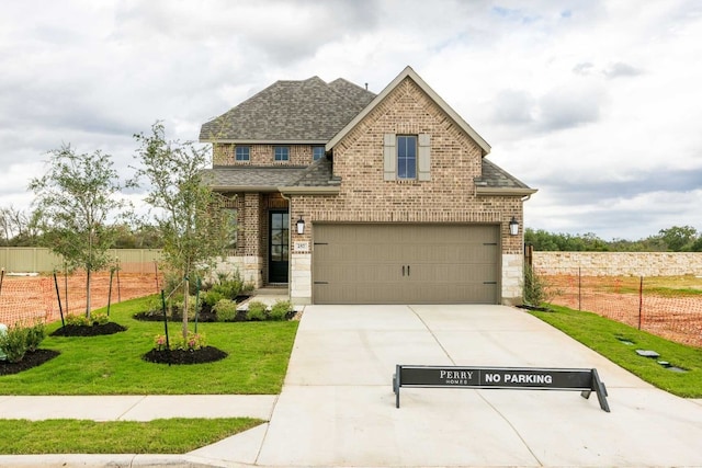 view of front of house featuring a front yard and a garage