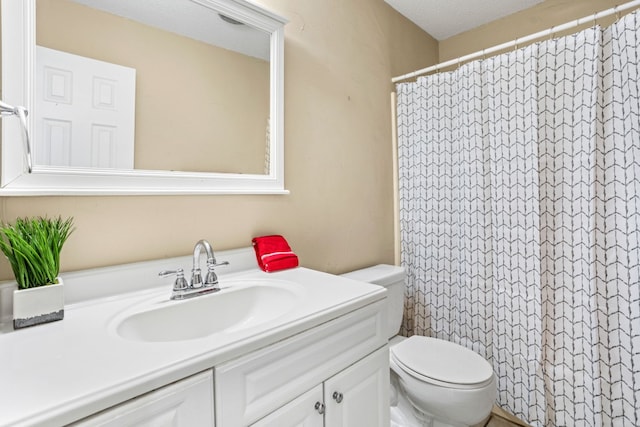 bathroom with a shower with shower curtain, toilet, and vanity